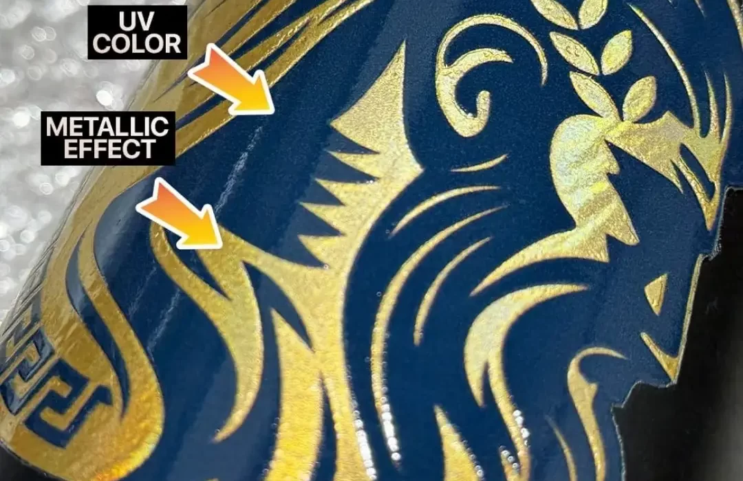 Close-up of a UV sticker design of Zeus in dark blue with hair in foiled golden colour on a black bottle.